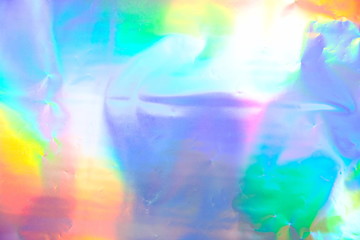 Abstract radiant festive backdrop texture image of holographic bokeh iridescent metallic foil