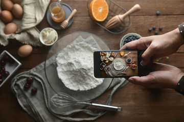The top view of the hand take photo of ingredients and method bakery or dessert with the smartphone...