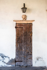 narrow door with capital