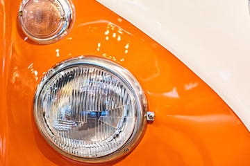 Headlight with halogen lamp on retro car, closeup