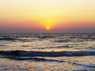 Horizontal shot of a beautiful sea sunset without clouds, orange sky. For backgrounds, templates, flyers, backdrops