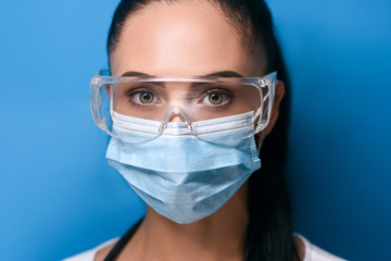 Young girl in eyeglasses, in a medical mask, large portrait