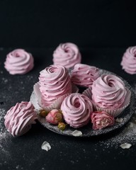 hand Homemade dessert, tender souffle, pink marshmallows, zephyr, close-up