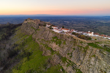 Marvao drone aerial view of the historic village and Serra de Sao Mamede mountain at sunset, in Portugal