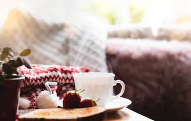 Still life Hot cuppa tea with steam with blurry foreground of toasted on a coffee table with morning light or Can be Cozy scene of relaxing in afternoon tea with bread in sunny day autumn or winter
