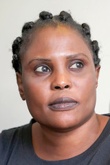 Face of sad african woman in profile looking up. Emotion of fear and despair. Portrait of a african woman face. Coseup.