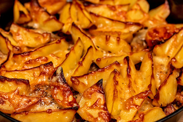 Baked potato wedges in sauce