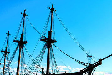Fototapeta premium Silhouette of an old, ancient, wooden ship with masts on a sunset background