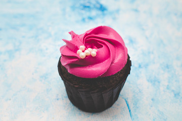 pink cupcake on a blue background