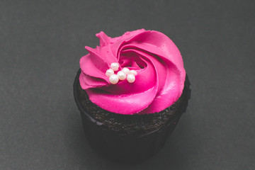 pink cupcake on a black background