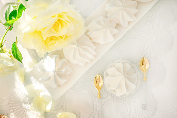 White handmade meringue on a white plate is served in an elegant style. Homemade cake