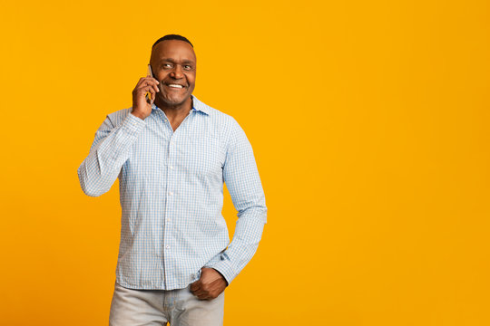 Cheerful Middle Aged African Man With Talking On Cellphone