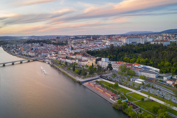 Obraz premium Coimbra drone aerial city view at sunset with Mondego river and beautiful historic buildings, in Portugal