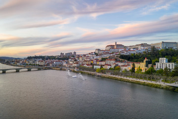 Fototapeta premium Coimbra drone aerial city view at sunset with Mondego river and beautiful historic buildings, in Portugal