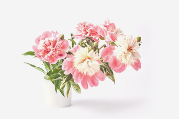 a bouquet of fresh peony flowers on a white background. beautiful pink floral. vase in the form of a tin bucket