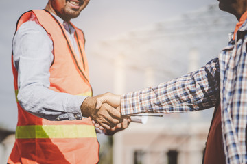 construction company handshaking with material supplier.