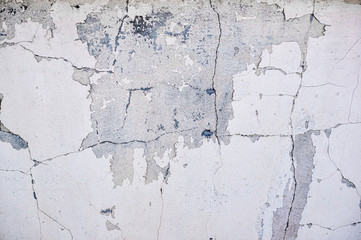 gray cement wall with deep cracks from old age and precipitation. Blank for the designer. Concrete wall