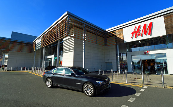  BMW Car on retail park outside H & M Store.