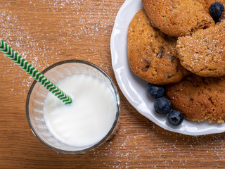 caramel dulce de leche biscuits with glass of milk on wooden table 