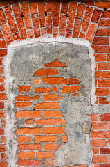 An old weathered fragment of a brick wall with fragments of a cement bond. Background for the designer. A large brick