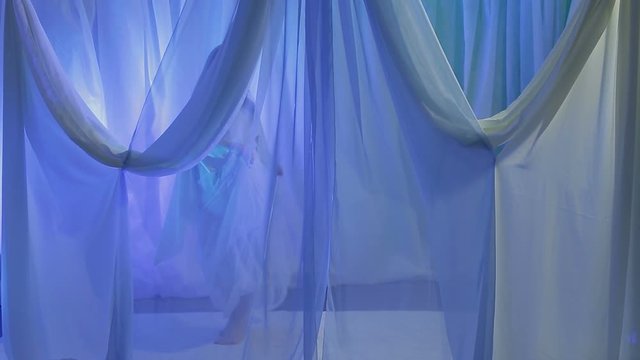 A young Jewish bride dances in front of a chuppah on the eve of the wedding