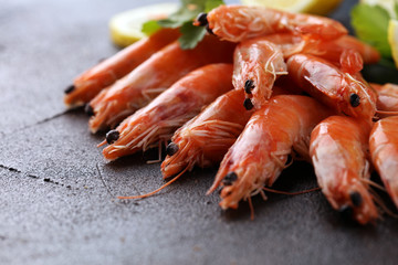 Raw fresh Prawns Langostino Austral. shrimp seafood with lemon and spices on background