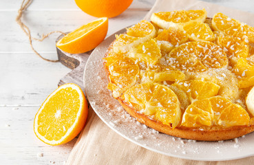 orange pie, slices of fresh orange on a white wooden background, baking,