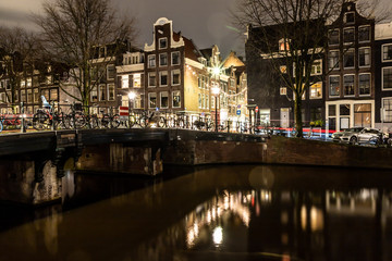 Fototapeta na wymiar Night lights of building and biclycles in Amsterdan