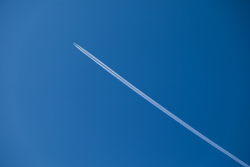 the plane is high in the sky and the trace of the plane