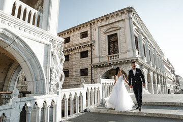 beautiful wedding couple,happy bride and groom go hands,happy bride looks at the groom,wedding...