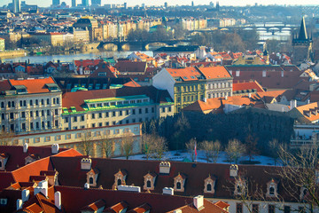 Fototapeta na wymiar View of the city and city streets, architecture and roofs houses from above. Prague,