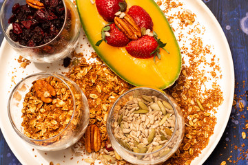 Melon pieces, on blue table with blue plate and seeds.