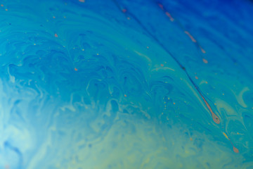 abstract background iridescent paint, colors iridescent interference rainbow on a soap bubble. The rounded surface of the sphere