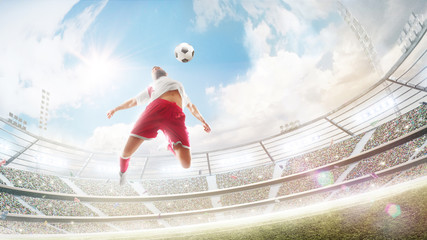 Wide angle. Taking the ball on the chest in football. The soccer player is jumping to hitting soccer ball with chest. Sport © Ruslan Shevchenko