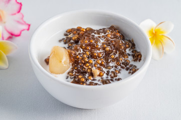 Thai desserts, sago desserts with longan topped with coconut milk