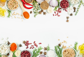 A variety of spices and herbs on a light table. Cooking background. View from above. Ingredients for cooking. Table background menu.