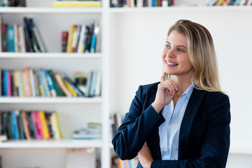Dreaming blond businesswoman with blazer