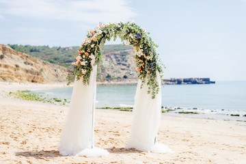 beach wedding venue, wedding setup, cabana, arch, gazebo decorated with flowers, beach wedding setup