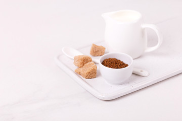 ingredients for dalgona coffee, milk and cane sugar. South Korean summer drink