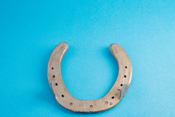 Horseshoe on blue background for good luck