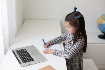 cheerfully cute girl children excited using computer learning schoolwork. kid enjoy e-learning in...