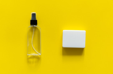 Soap and antiseptic lie on a yellow background. Anti-virus protection kit against covid-19. Coronavirus pandemic 2019.