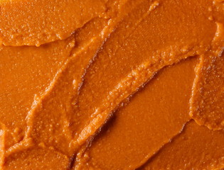 Tomato flavored hummus surface, background and texture