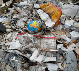 Garbage dump. Broken terrestrial globe in the garbage
