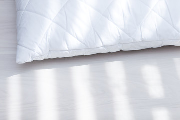 White hypoallergenic pillow in sunny day, sunlight. Allergy dust mite concept.