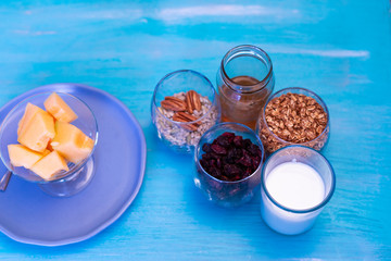 Melon pieces, on blue table with blue plate and seeds.
