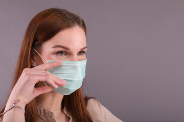 Portrait of Woman in Surgical mask against Covid-19 (coronavirus)