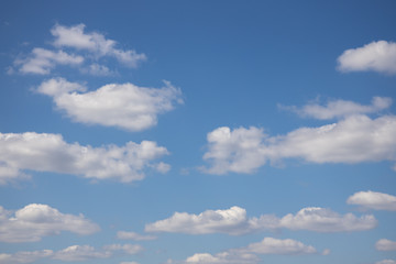 Naklejka na ściany i meble blue sky on a sunny warm day with white and gray clouds