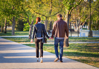 lovers walk in the Park and hold hands. Friendship, love, family. Concept of family values.