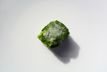 A block of frozen spinach onwhite background 